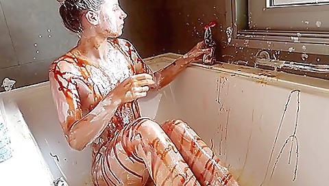 Solo female with a hairy pussy eats a big piece of milk