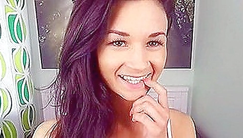 Hot brunette girl in a sexy outfit is showing her body