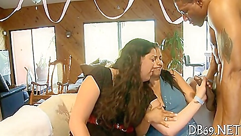 Busty milf in a group of sex slaves is doing handjob